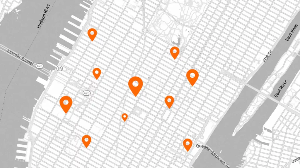 Map with orange location pins in different sizes.